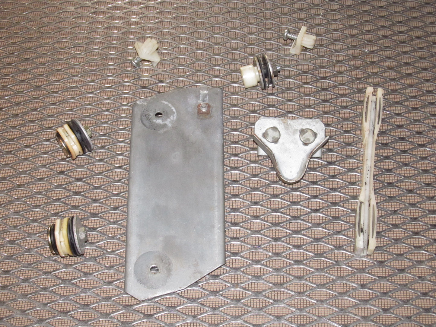 79 80 Datsun 280zx OEM Window Roller Stopper & Bracket - Left